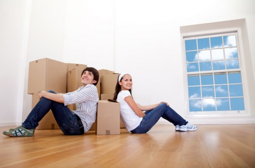 Professional team handling office moving boxes and equipment