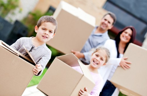 Helper carrying boxes for a Mortlake man with a van job