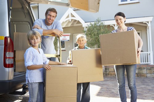Furniture and boxes being loaded into a moving van in southwest London