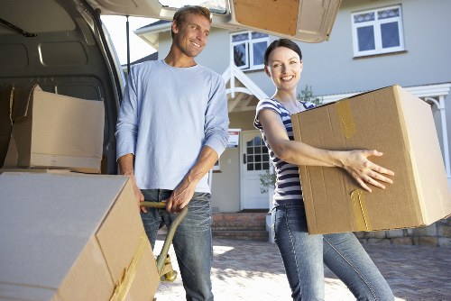Mover carefully loading furniture into a van